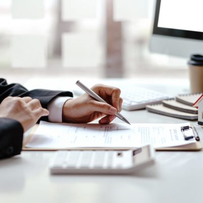 Real estate agent and customer make contract to buy and sell house and land. Approval of a contract to buy or sell a home. Offers mortgage loans and home insurance concept.